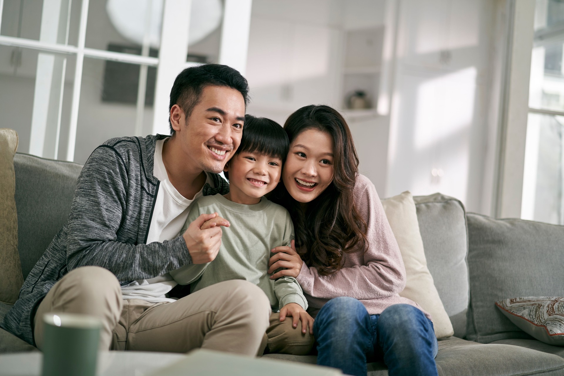 young asian family with two kids having a good time at home